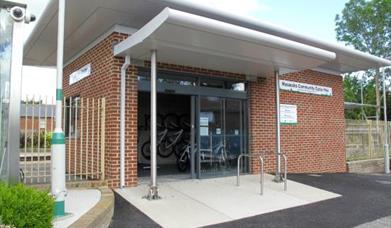 a utility building next to the train station where the community bikes are stored and rented from