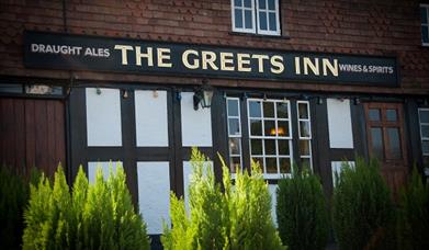 Outside sign of The Greets Inn in Warnhum