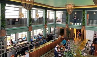 view of the inside of the art deco style restaurant looking down from the balcony seating on the second level