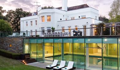 view of the estate house with the indoor swimming pool through the glass frontage