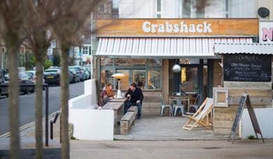 Diners enjoying outside seating area at Crabshack