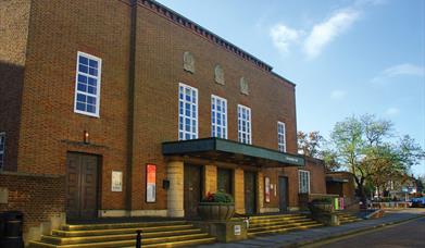 External shot of Assembly hall venue in Worthing, a brick building with large windows