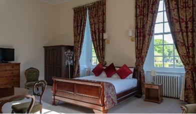 castle room with big windows and period furniture
