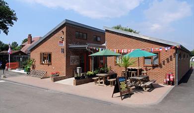 main campsite building with outside seating