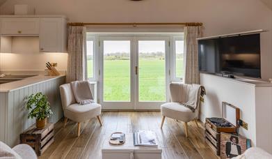 two chairs over looking field tv in room
