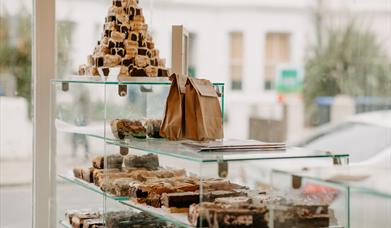 A view from behind our counter. Glass cabinets filled with brownies, blondies and brookies.