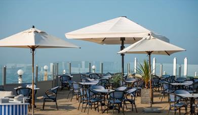 the terrace view of tables overlooking the sea