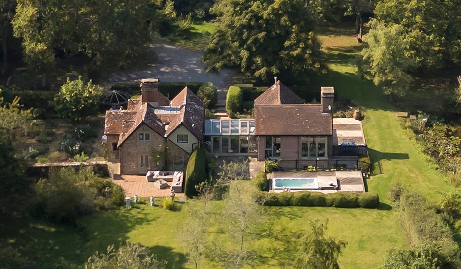 Aerial country property with pool in woods