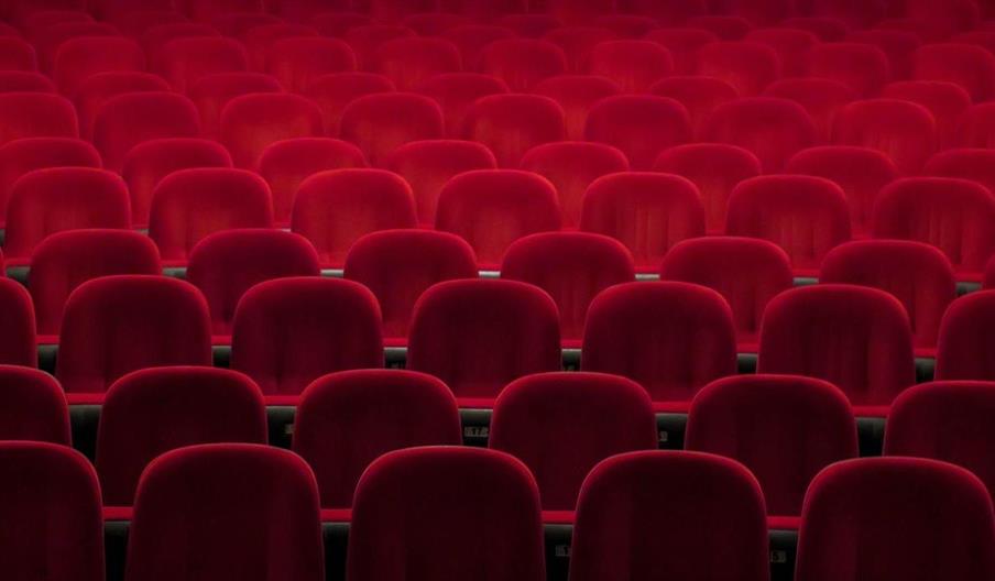 Empty red seats in a theatre