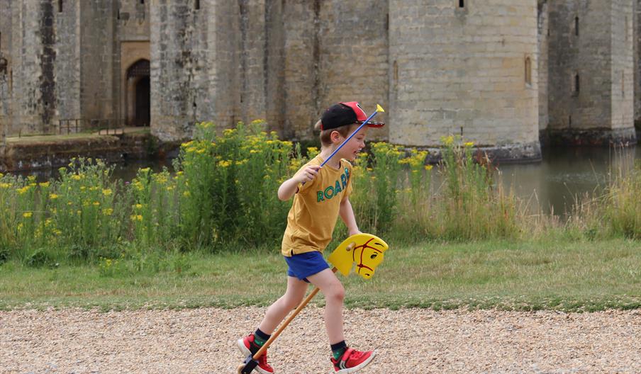 Child playing with a hobby horse.