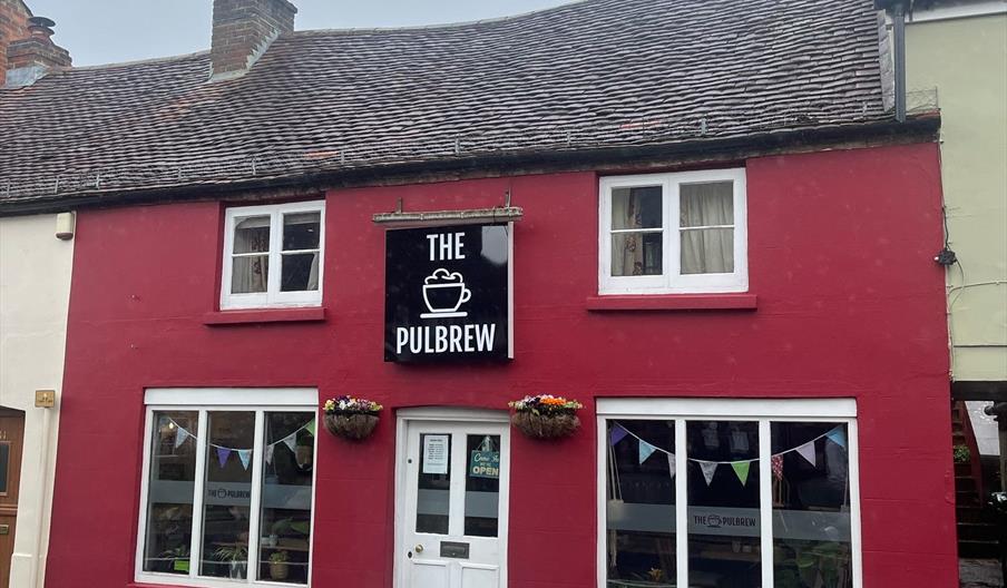 the red building with the sign The PulBrew