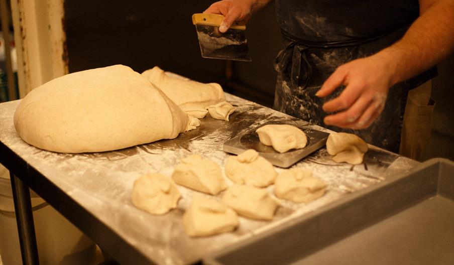 Dough being cut on a board