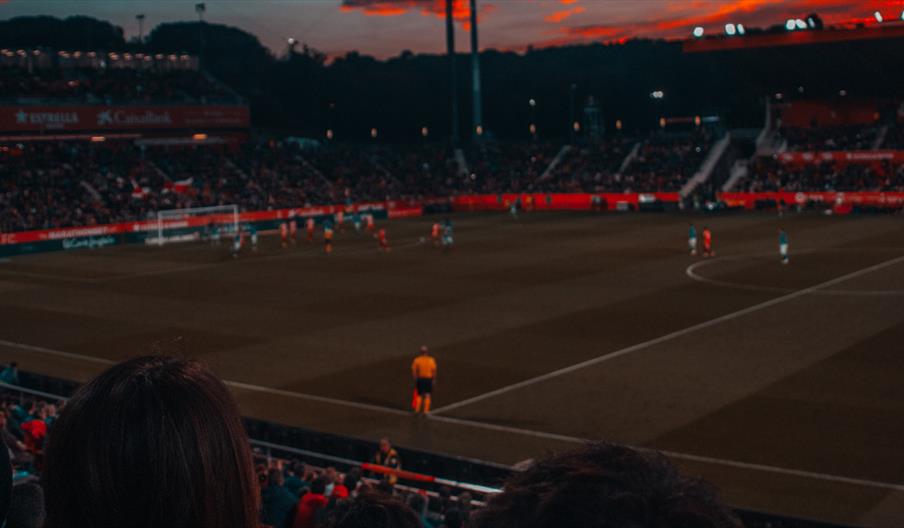 Football game at sunset in stadium