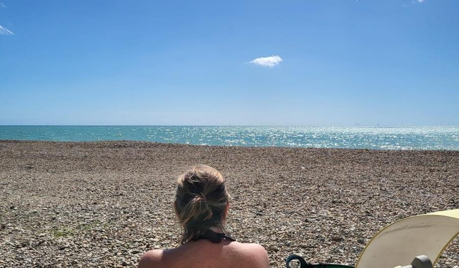 Woman in deck chair looking out to sea at Widewater sauna