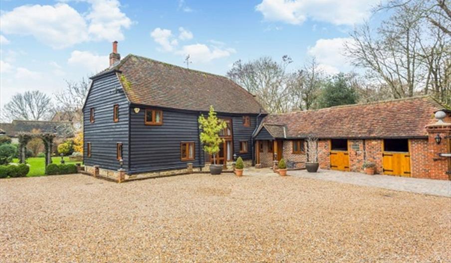 A renovated cladded barn and outbuildings in Sussex providing luxury accommodation for famileis and groups