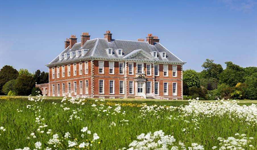 view of the house from the grounds on a sunny summers day