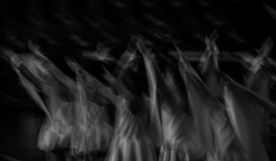 Black and white image capturing dancers in motion