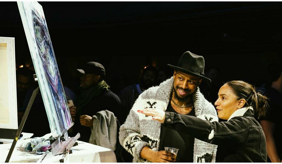 A couple discussing an art work on an easel