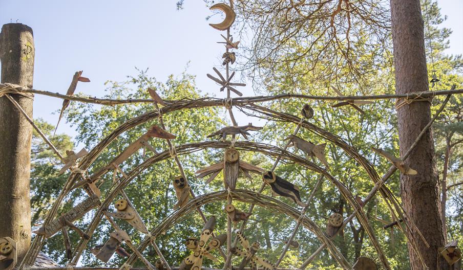 Community made entrance arch at the top of the woods