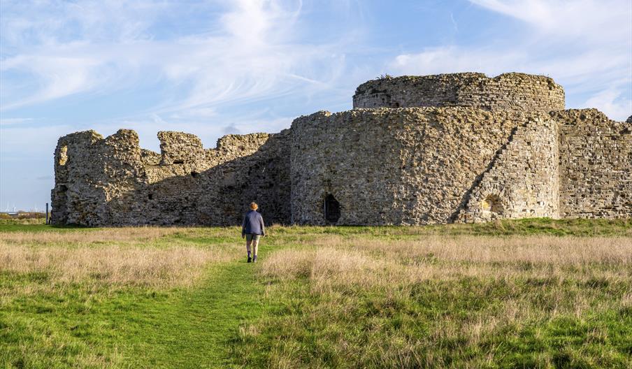 the front side of the ruins with a person walking towards them