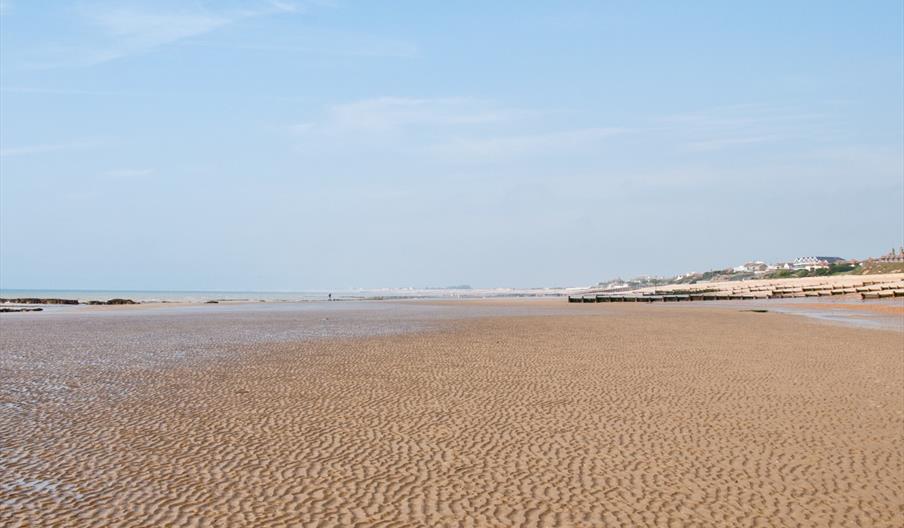 Cooden beach with blue skies and sand