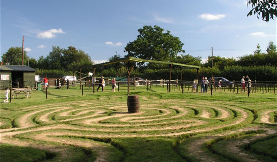 an outdoor maze in the grass field.