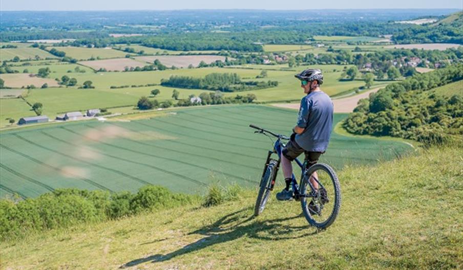 man on mountain bike over looking the downs