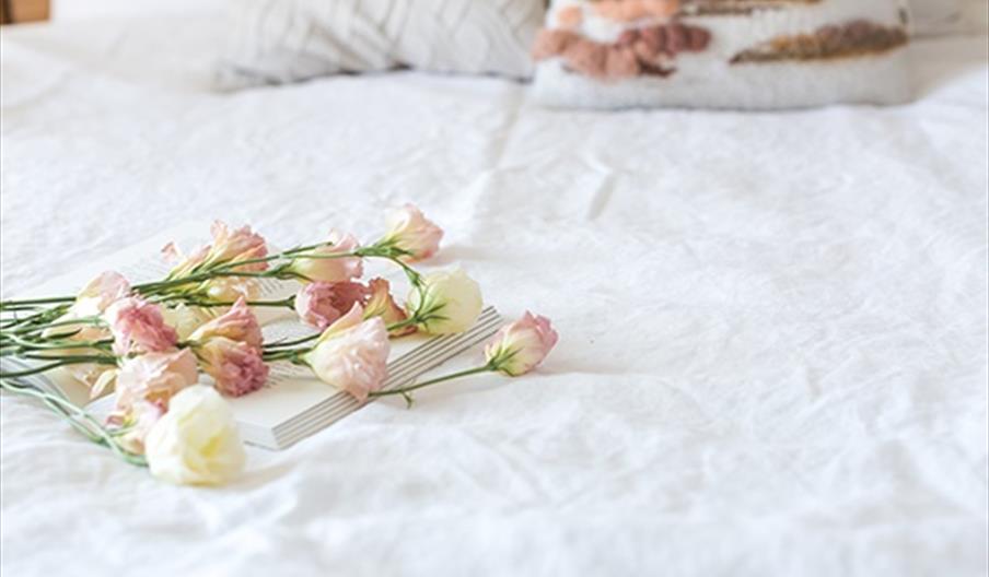Old House Inn white bed spread with pastel flowers