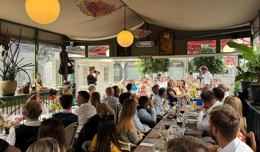 people at a long dining table