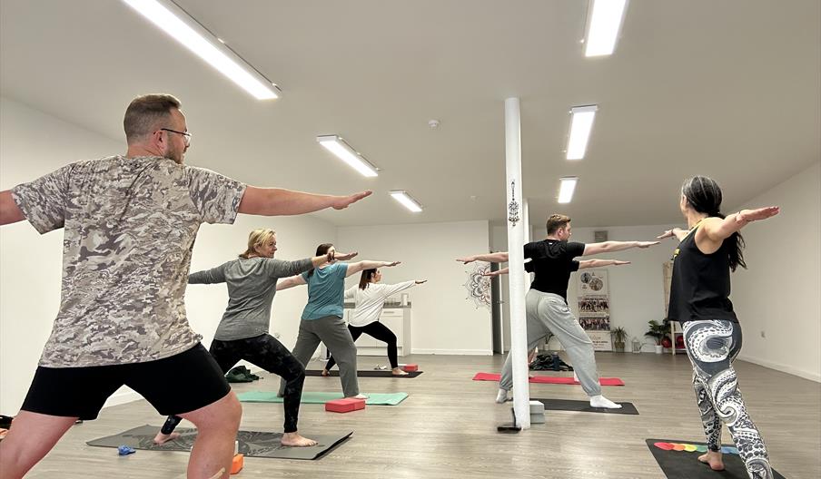People doing yoga in room