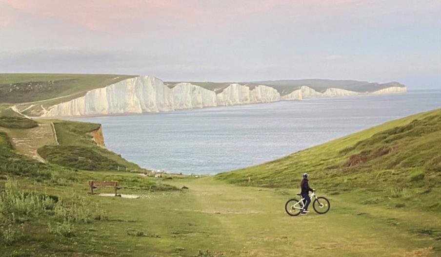 distant view of Seven Sisters and a lone cyclist