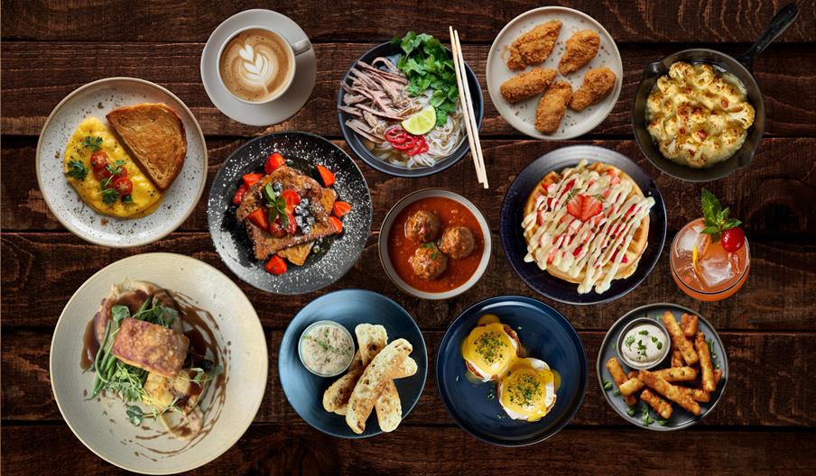 a table of plates of food showing a range of choices