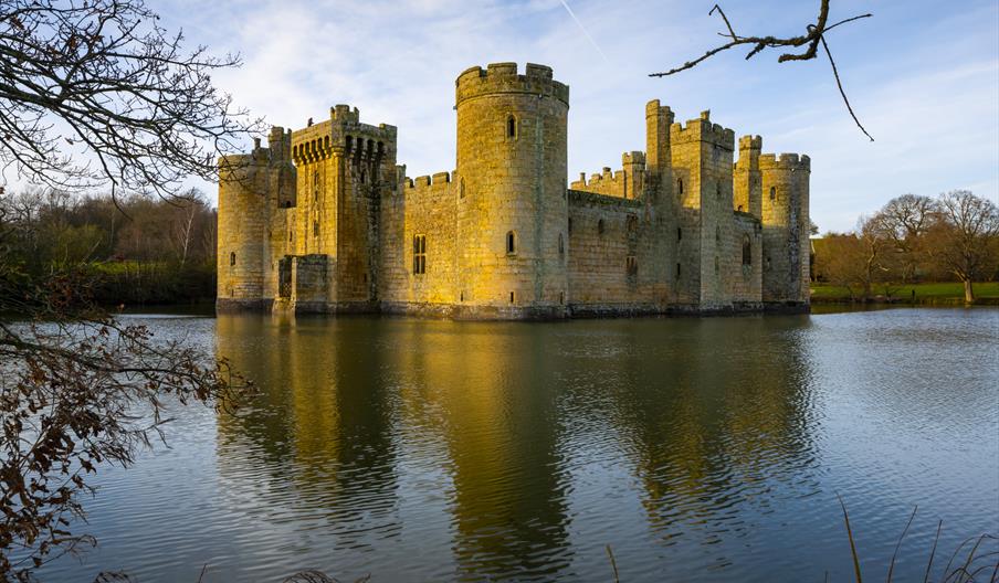 National Trust Bodiam Castle surrounded by water in the sunset