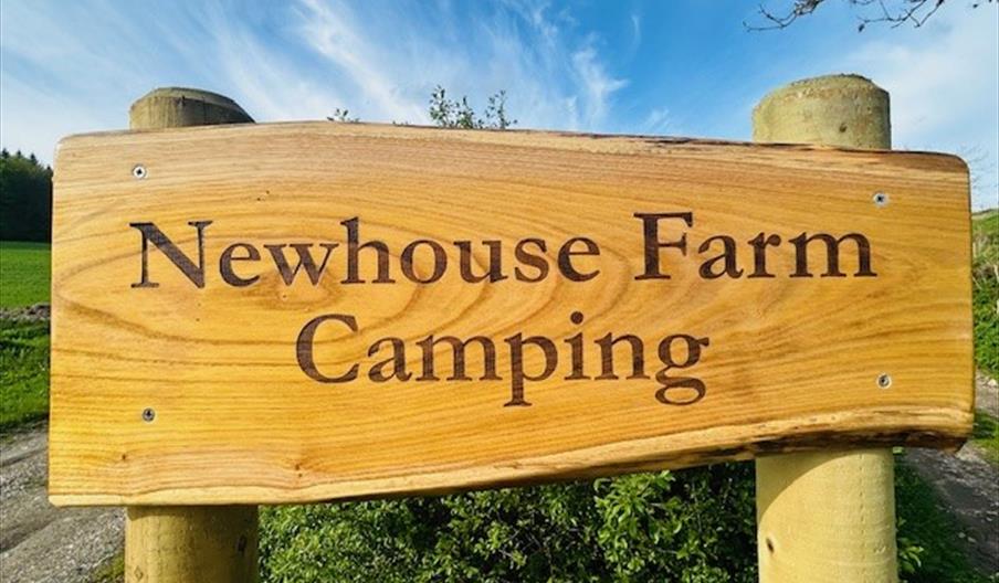 Newhouse Farm Camping wooden sign