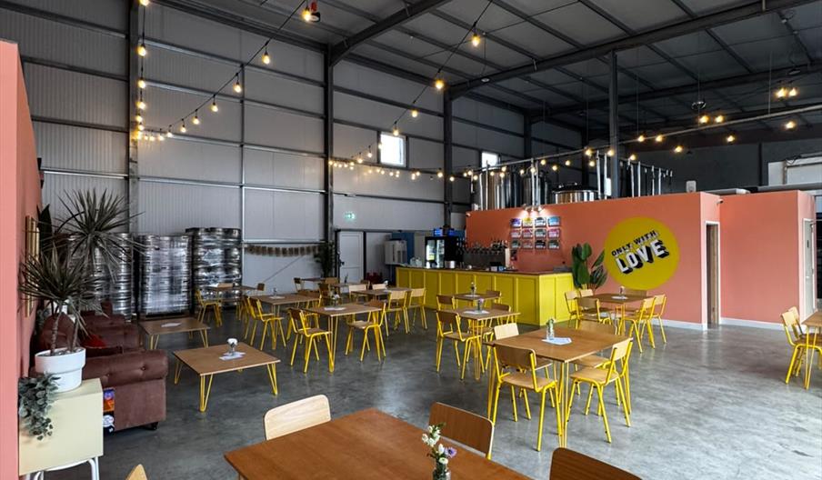 view of the taproom with tables and chairs