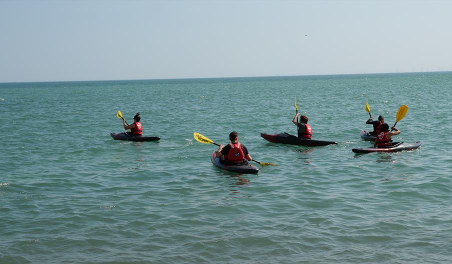 four people Kayaking on Brighton sea front