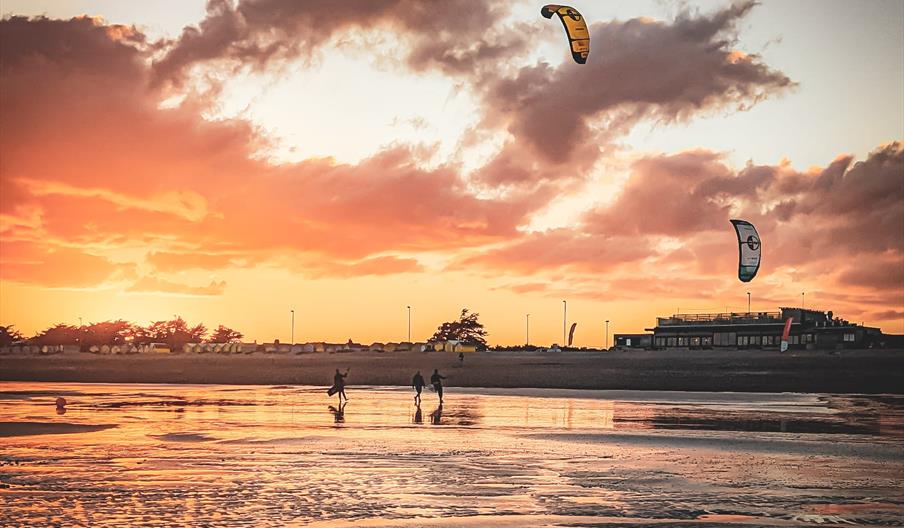 Kitesurfers on Littlehampton beach with a sunset