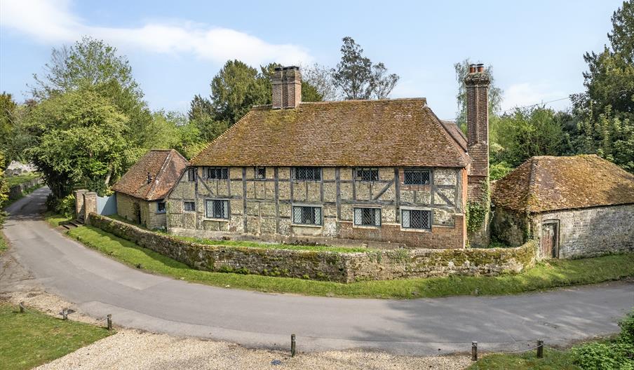 outside of the house showing its architectural style with trees in the background