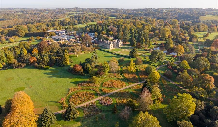 drone image of Wakehurst including the Mansion and surrounding lawns, pond and trees
