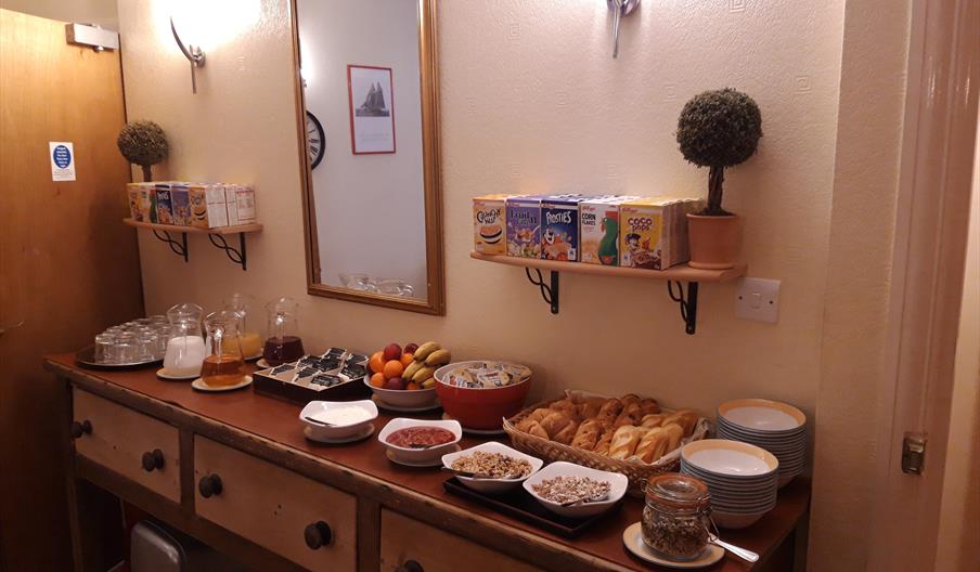 Breakfast table with an array of breakfast items for guests to self serve