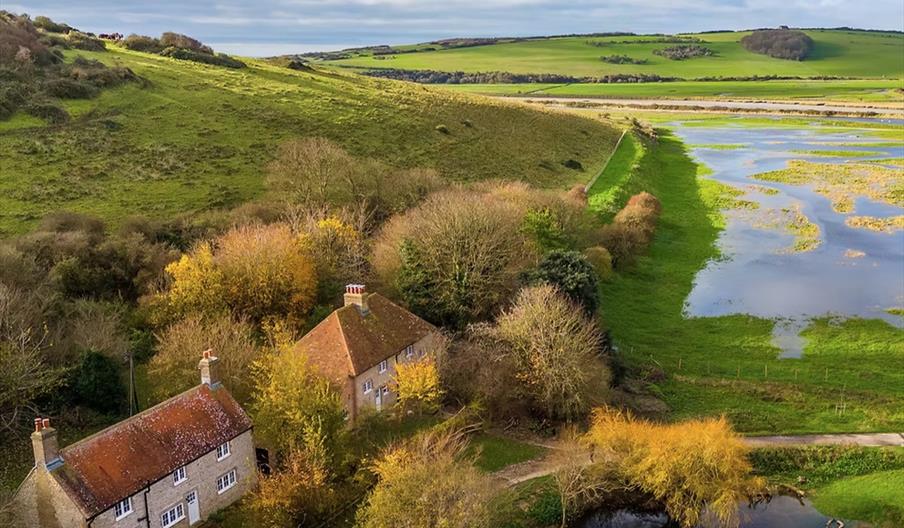 the cottages in the wider seven sisters park with view of the wetlands and pond