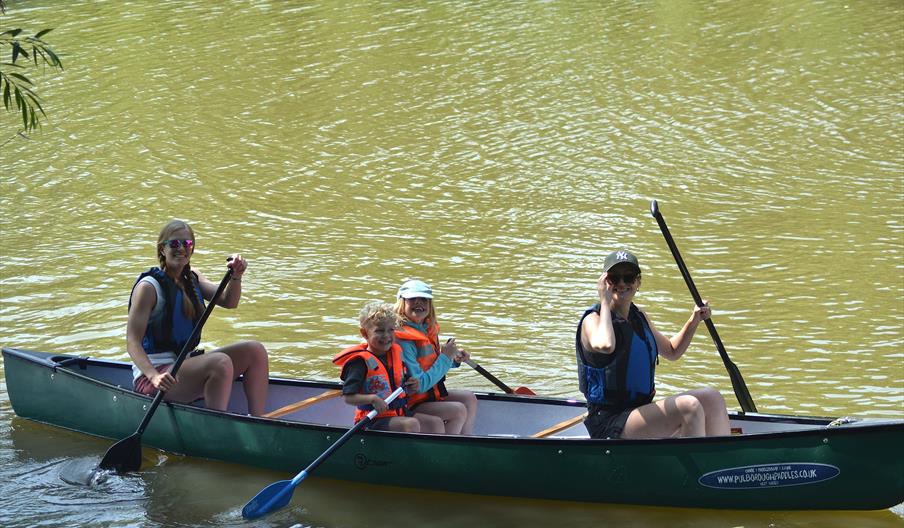 a family in a canoe on the river