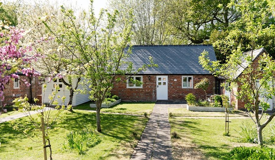 view of the cottage entrance and a big front garden