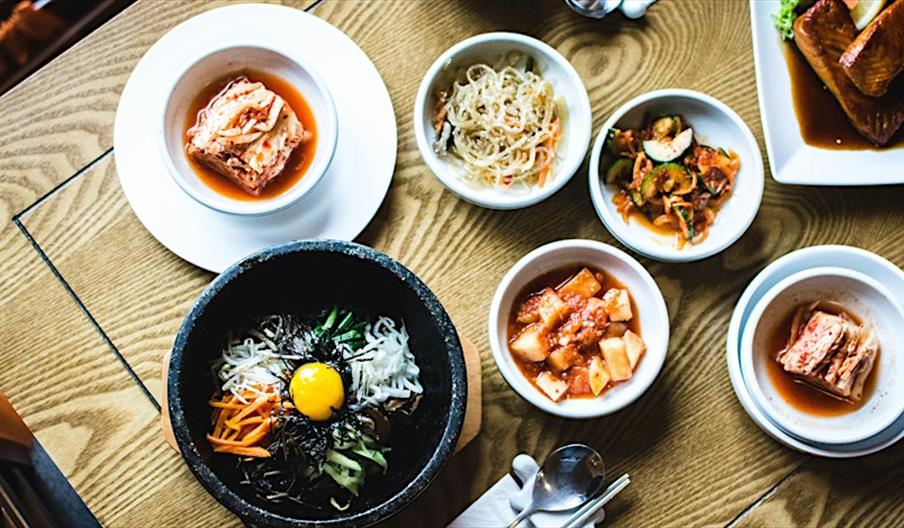 various plates of food arranged on a table