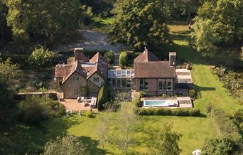 Aerial country property with pool in woods