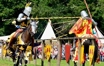 Two jousters wearing colourful medieval armour