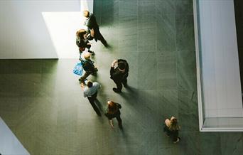 Top down view of people in grey space