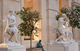 White marble statues outside museum