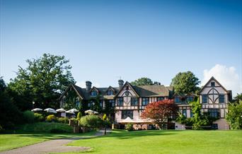 Outside of Mannings Heath Golf & Wine Estate showing green grass and outdoor seating