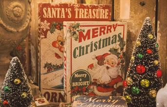 Books with Santa on the front and two tiny Christmas trees
